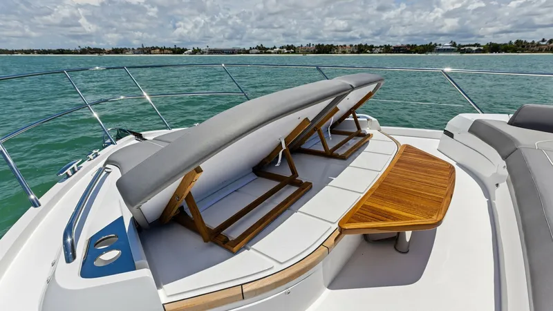Slide: The Image of Bow Sunbathing Area with Adjustable Loungers Experience ultimate relaxation on the 2026 PRINCESS V55's bow sunbathing area, featuring plush adjustable loungers for personalized comfort. The sleek design is complemented by a stylish teak table, perfect for enjoying refreshments while taking in the pa - 6312369