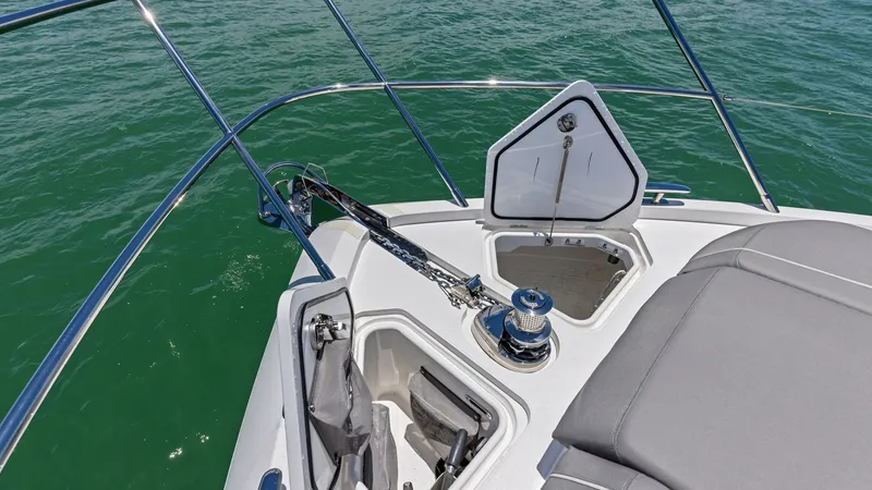 Slide: The Image of Windlass Foredeck The 2026 PRINCESS V55's bow features an elegantly designed anchor locker with stainless steel fittings, showcasing functionality and style. Adjacent to the locker, a plush sunpad invites relaxation, offering a perfect spot for sunbathing while enjoying pa - 6312370
