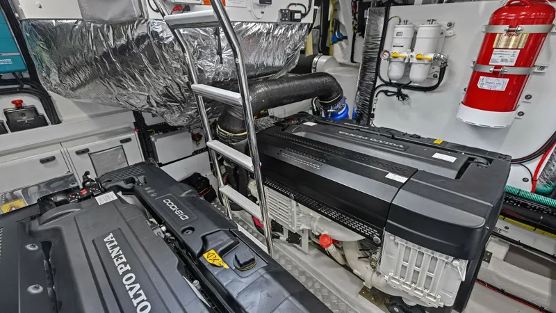 Slide: The Image of Engine Room with Volvo Penta Engines The engine room of the 2026 PRINCESS V55 showcases powerful Volvo Penta engines, ensuring top-tier performance and reliability. The space is meticulously organized, featuring a sturdy ladder for easy access and well-insulated components for noise reductio - 6312374