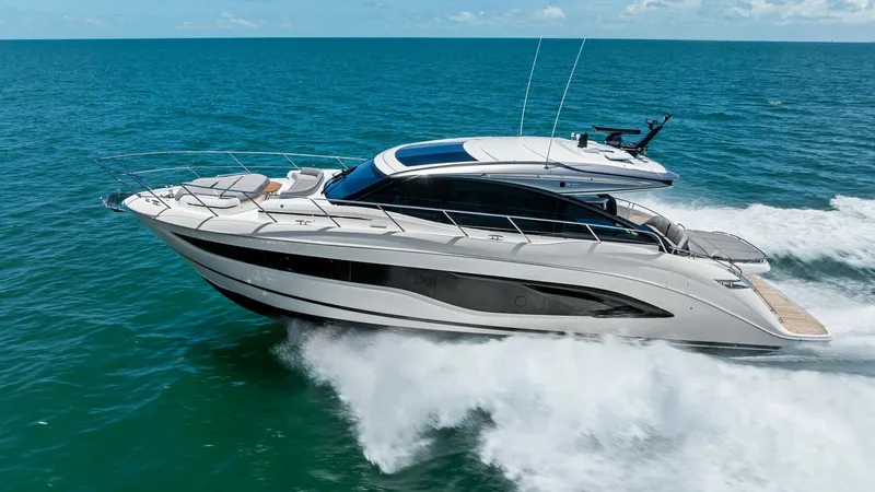 Slide: The Image of Side View of Princess V55 The 2026 Princess V55 showcases sleek, aerodynamic lines as it glides effortlessly across the water. Its modern hull design and expansive side windows offer both style and functionality, ensuring a luxurious cruising experience. The spacious deck and adva - 6312379