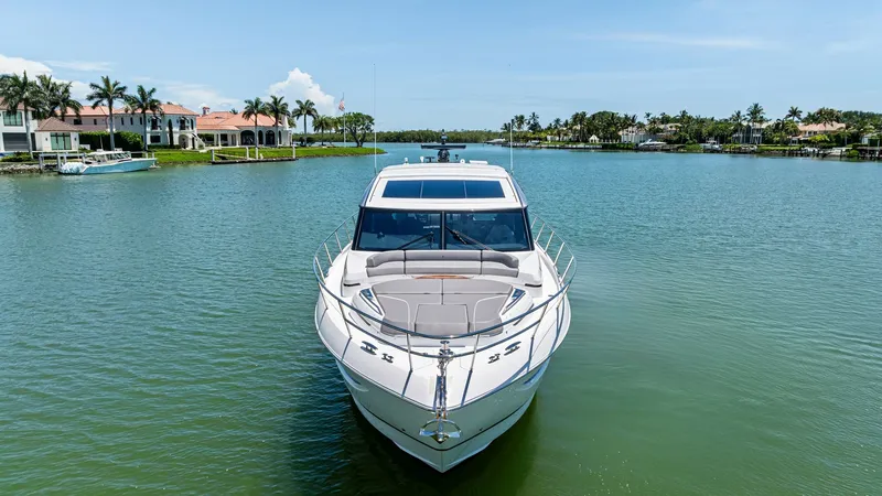 Slide: The Image of Bow View with Sunpad Lounge and Seating Area The 2026 PRINCESS V55 showcases a sleek bow design featuring a spacious sunbed lounge, perfect for basking under the sun. The elegant lines and polished stainless steel rails accentuate the modern aesthetics of this luxury vessel. Expansive windows provid - 6312328