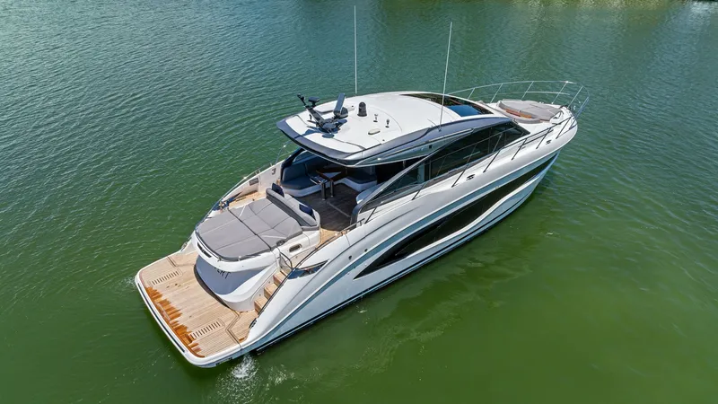 Slide: The Image of Aerial View of Cockpit Deck This aerial view showcases the elegant aft deck and cockpit of the 2026 PRINCESS V55. The spacious aft deck features a luxurious sunbed area, perfect for relaxation and sunbathing, complemented by teak decking for a touch of sophistication. The sleek line - 6312331