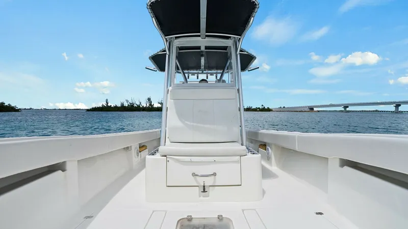 Slide: The Image of Center Console and Bow Area This image showcases the sleek and functional center console of the 2015 SeaVee 320Z. The spacious bow area features clean lines and ample storage beneath the seating, perfect for both relaxation and utility. The overhead T-top provides shade and protecti - 6312127