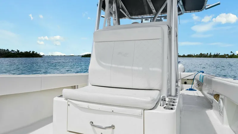 Slide: The Image of Center Console Bow Seating Area This image showcases the well-appointed center console seating area on the 2015 SeaVee 320Z. The cushioned seat provides comfortable seating with convenient access to storage below, ideal for extended trips. The design emphasizes functionality and style, - 6312128