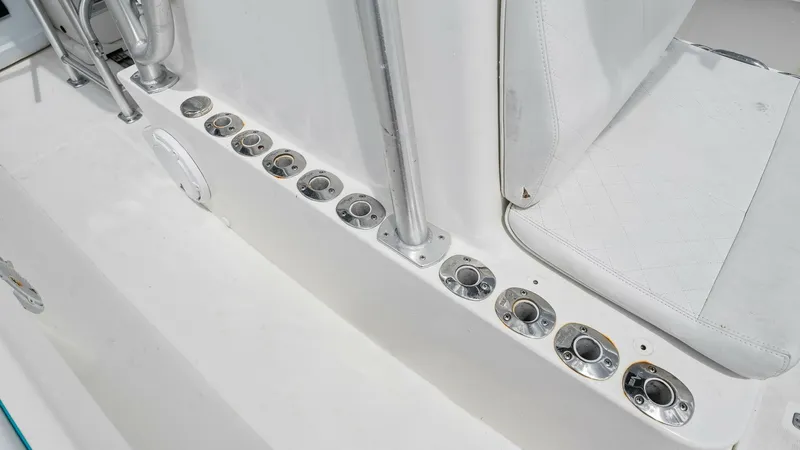 Slide: The Image of Fishing Rod Holders and Seating Area This image showcases the fishing rod holders along the side of the vessel, highlighting the Reel Tension's commitment to angler convenience. The integrated seating provides comfort during long fishing trips, while the sturdy construction ensures durabilit - 6312130