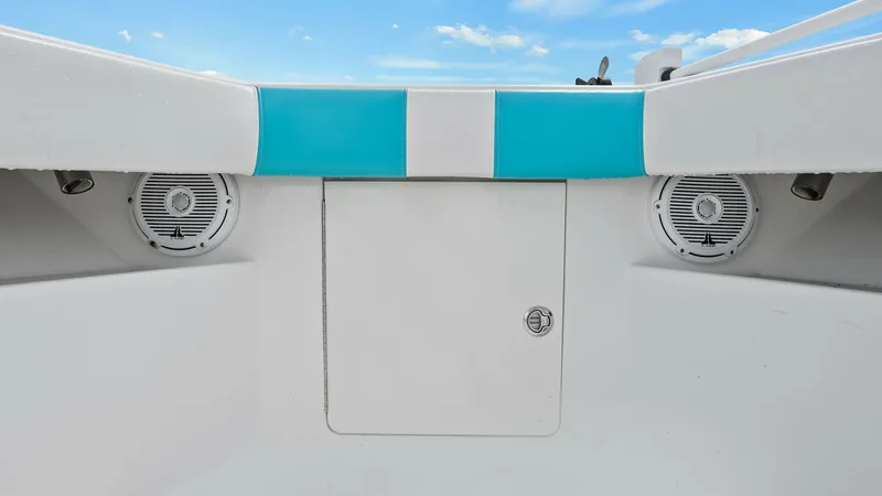 Slide: The Image of Aft Storage Compartment with Speakers This image showcases the aft section of the SeaVee 320Z, featuring a central storage compartment. Flanking the compartment are two integrated marine-grade speakers, offering an enhanced audio experience on the water. The clean design and vibrant blue acce - 6312135