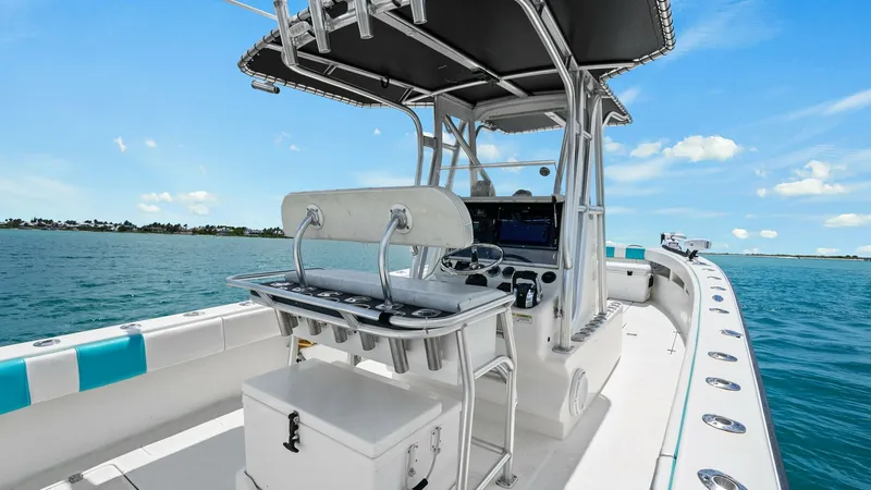 Slide: The Image of Center Console Helm with T-Top The SeaVee 320Z's center console helm is equipped with state-of-the-art navigation systems and a sleek steering wheel, providing an optimal driving experience. Its T-top offers ample shade and protection from the elements, while the seating area is design - 6312118