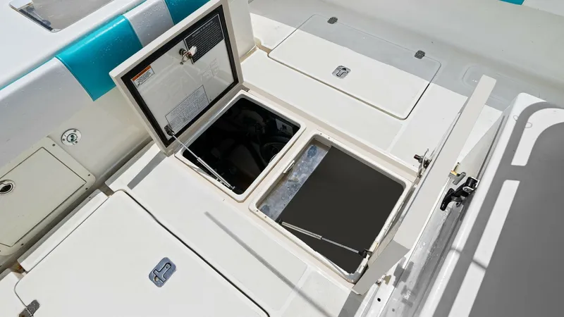 Slide: The Image of Aft Deck with Storage Compartments The aft deck of the 2015 SeaVee 320Z 'Reel Tension' features spacious storage compartments, ideal for stowing gear and equipment. The neatly arranged hatches offer easy access and are seamlessly integrated into the deck design. The area is accented with v - 6312141