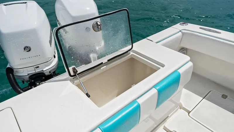 Slide: The Image of Aft Deck with Livewell and Engines This image showcases the aft deck of the 2015 SeaVee 320Z, featuring a built-in livewell with a secure, transparent lid. The twin outboard engines provide impressive power and efficiency, ideal for offshore fishing adventures. The clean, spacious layout i - 6312143