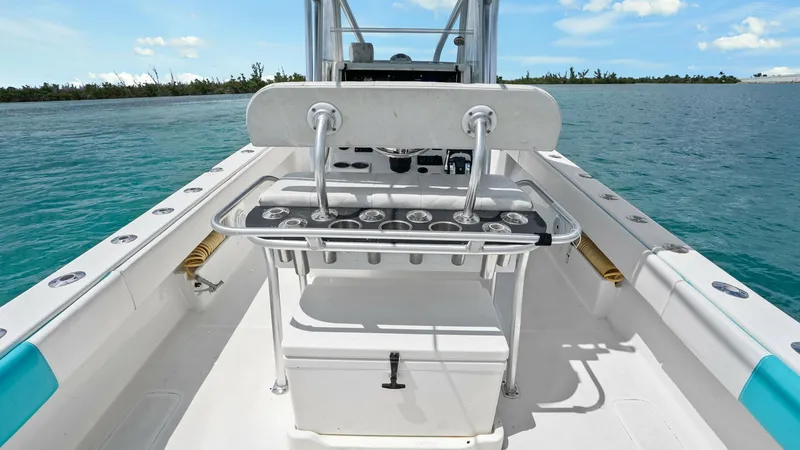 Slide: The Image of Aft Deck with Tackle Station This view of the 2015 SeaVee 320Z showcases the aft deck, featuring a well-equipped tackle station ideal for fishing enthusiasts. The spacious layout provides ample room for movement, with built-in rod holders and a large storage cooler beneath. The clean - 6312119
