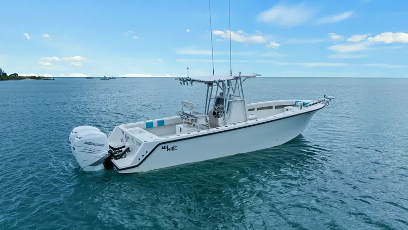 Slide: The Image of Aft and Starboard Exterior View This image showcases the sleek exterior of the 2015 SeaVee 320Z from the aft and starboard side. The vessel is equipped with powerful twin Mercury outboard engines, promising a robust performance on the water. The clean lines and open deck space highlight - 6312149