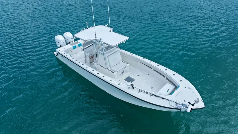 Slide: The Image of Aerial View of Center Console This image showcases the spacious deck of the 2015 SeaVee 320Z, featuring a sleek center console design ideal for fishing and leisure. The twin outboard engines promise powerful performance, while the T-top offers shade and protection. The open layout pro - 6312121