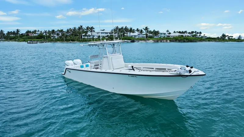 Slide: The Image of Elegant Bow Profile at Anchor The 2015 SeaVee 320Z 'Reel Tension' is beautifully showcased at anchor, highlighting its sleek bow design and robust hull. The clean, white finish complements its modern lines, while the spacious deck promises ample room for fishing or leisure. This vesse - 6312122