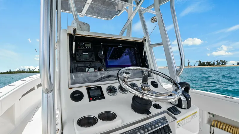 Slide: The Image of Helm Station with Electronics The helm station of the 2015 SeaVee 320Z 'Reel Tension' features advanced navigation electronics and a sleek stainless-steel steering wheel. The ergonomic layout ensures easy access to controls and gauges, enhancing the captain's experience. The open desi - 6312123