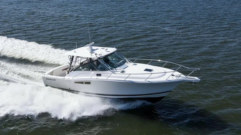 The Image of Dynamic Starboard Bow View in Motion The Wellcraft 360 Coastal, 'Unbridled', glides effortlessly through the water, showcasing its sleek starboard bow profile. The aerodynamic design enhances both speed and efficiency, while the sturdy railings and spacious foredeck provide safety and utilit - 6312497