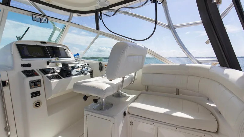 Slide: The Image of Helm Station with Seating Area The helm station of the Wellcraft 360 Coastal features a sophisticated control panel with modern navigation equipment, ensuring precise handling. The captain's chair offers ergonomic comfort, complemented by an adjacent curved seating area wrapped in luxu - 6312508