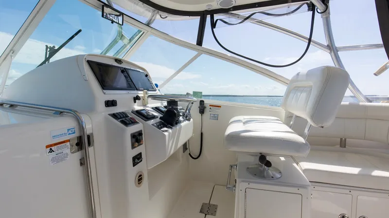 Slide: The Image of Helm Station with Seating Area The helm station of the 2006 Wellcraft 360 Coastal features a well-equipped dashboard with modern navigation instruments, offering optimal control and visibility. A plush captain's chair provides comfort for long journeys, complemented by a spacious seati - 6312509