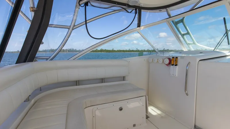 Slide: The Image of Spacious Cockpit Seating Area The cockpit of the 2006 Wellcraft 360 Coastal offers a comfortable seating area with wraparound cushions, perfect for social gatherings or relaxation. The large windows provide panoramic views and ample natural light, enhancing the open and airy feel. Dur - 6312514