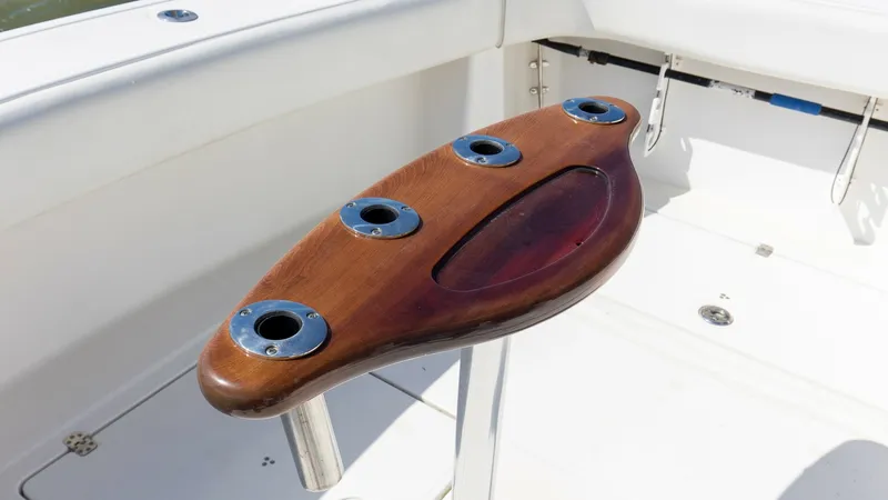Slide: The Image of Cockpit Fishing Station The Wellcraft 360 Coastal's cockpit features a robust fishing station with a beautifully finished wooden surface and multiple rod holders. This setup provides ample space and organization for serious anglers. The durable construction ensures longevity, ma - 6312517