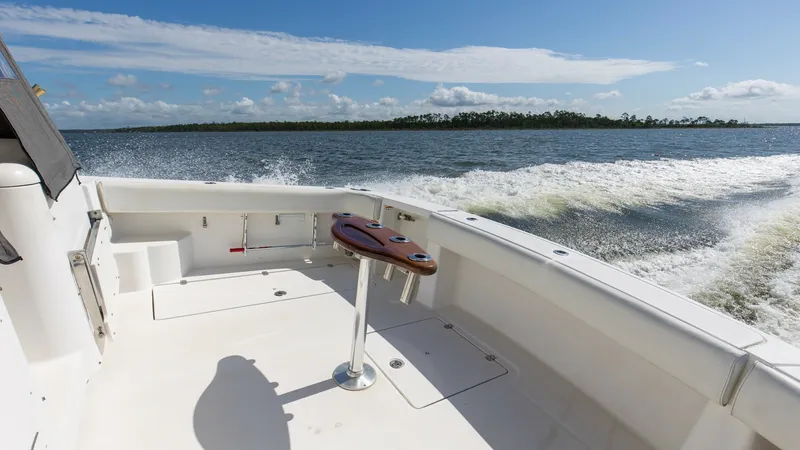 Slide: The Image of Spacious Aft Deck with Rod Holders The aft deck of the 2006 Wellcraft 360 Coastal offers ample space, perfect for fishing or relaxing. It features integrated rod holders and a sturdy, sleek table, enhancing functionality and style. The open layout provides breathtaking views of the water, - 6312518