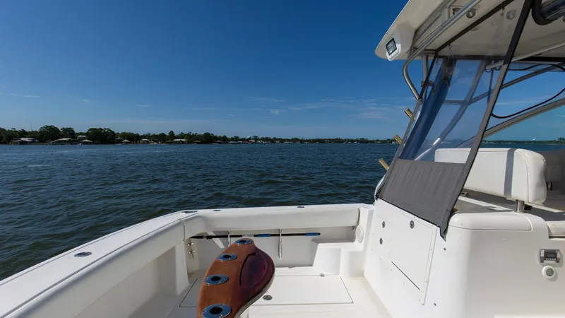 Slide: The Image of Aft Deck with Fishing Rod Holders The aft deck of the 2006 Wellcraft 360 Coastal showcases a spacious fishing area, complete with multiple rod holders. The clean, white surfaces are complemented by a high-quality wooden panel, enhancing the vessel's aesthetic appeal. The area provides amp - 6312519