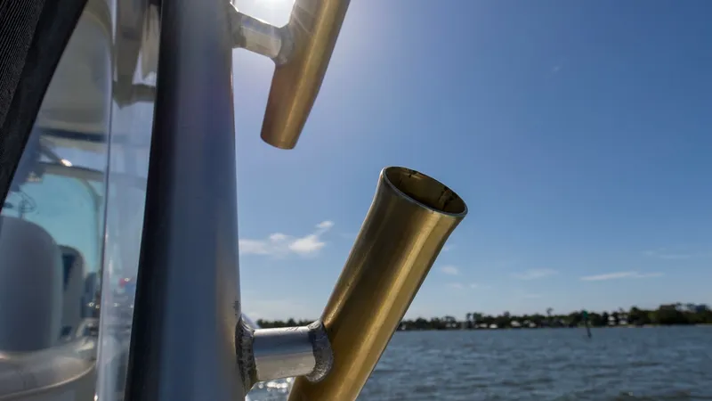 Slide: The Image of Side View with Rod Holders This image showcases the sleek side profile of the Wellcraft 360 Coastal, highlighting its functional rod holders. The sturdy stainless steel fittings are perfect for avid anglers, offering convenience and durability. The backdrop of calm waters and clear - 6312520