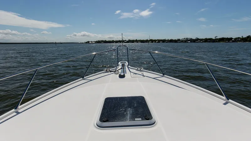 Slide: The Image of Bow Deck with Hatch View The expansive bow deck of the 2006 Wellcraft 360 Coastal offers a pristine view over the water. This area features a sturdy hatch, providing easy access to below-deck storage. The sleek railing enhances safety while maintaining the vessel's elegant lines, - 6312522