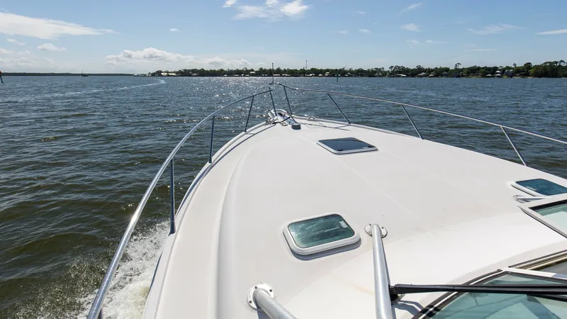 Slide: The Image of Bow View with Deck Hatches This image captures the sleek bow of the 2006 Wellcraft 360 Coastal, showcasing its spacious deck with dual hatches providing natural light below. The sturdy stainless steel railings offer safety and elegance as you enjoy clear views of the open water. It - 6312523