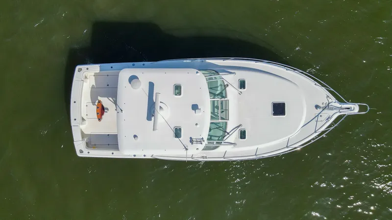 Slide: The Image of Aerial View of Wellcraft 360 Coastal This aerial shot showcases the sleek design of the 2006 Wellcraft 360 Coastal, highlighting its spacious deck layout. The clean lines and ample deck space are ideal for both fishing and leisure activities, while the sturdy bow rail provides safety and sty - 6312526