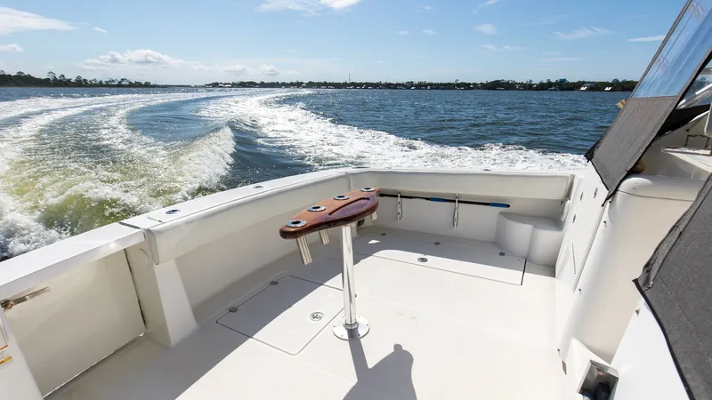 Slide: The Image of Spacious Aft Deck with Rod Holders The aft deck of the 2006 Wellcraft 360 Coastal offers ample space for fishing and relaxation. Equipped with multiple rod holders and a sturdy work table, it's ideal for anglers. The clean, open layout allows for easy movement and access to the water, maki - 6312500