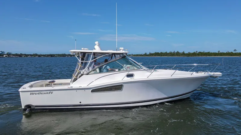 Slide: The Image of Starboard Profile of Wellcraft 360 Coastal This image showcases the sleek starboard profile of the 2006 Wellcraft 360 Coastal. The vessel's distinctive lines and well-maintained hull highlight its sporty yet elegant design. With a spacious cockpit and robust hardtop, this model is perfect for both - 6312527