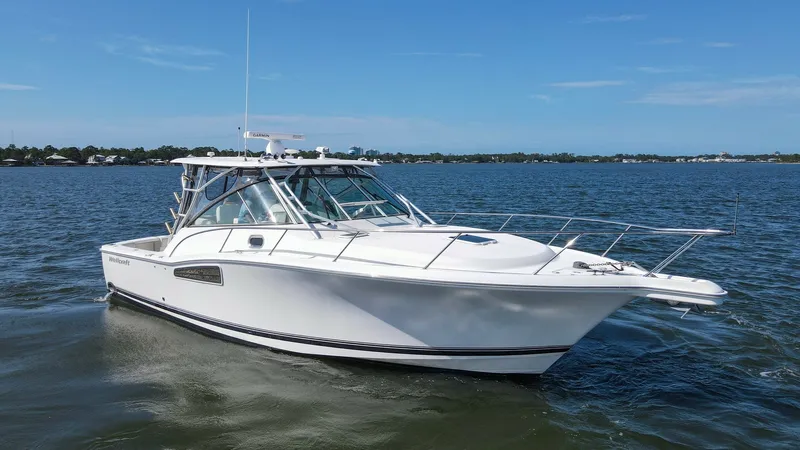 Slide: The Image of Exterior View of Wellcraft 360 Coastal This image showcases the sleek exterior of the 2006 Wellcraft 360 Coastal, featuring its streamlined hull and spacious deck design. The vessel's elegant white finish is complemented by robust stainless steel railings and a well-appointed hardtop. Ideal fo - 6312528
