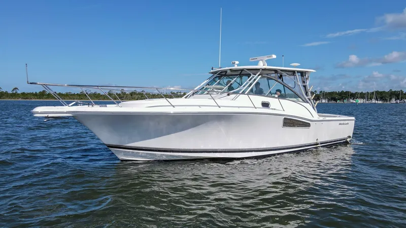 Slide: The Image of Port Side Exterior View This image showcases the sleek port side profile of the 2006 Wellcraft 360 Coastal, highlighting its graceful lines and robust construction. The vessel's expansive deck and sturdy railings are designed for both functionality and style, ensuring a safe and - 6312530