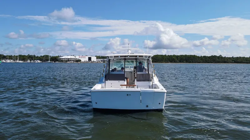 Slide: The Image of Aft View of Wellcraft 360 Coastal This image showcases the sleek aft section of the 2006 Wellcraft 360 Coastal, named 'Unbridled.' The spacious cockpit area is designed for both leisure and sport, offering ample seating and easy access to the water. The sturdy construction and elegant lin - 6312532
