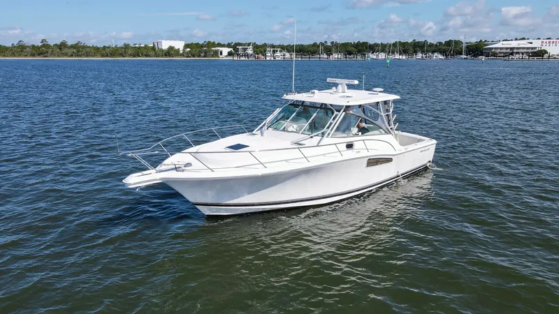 Slide: The Image of Starboard View of Wellcraft 360 Coastal The Wellcraft 360 Coastal, built in 2006, is showcased here from the starboard side, highlighting its sleek lines and robust build. The vessel's hardtop and spacious cockpit are designed for comfort and functionality, ideal for both cruising and fishing. - 6312533