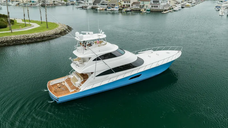 Slide: The Image of Aerial View of Viking 92 Skybridge This stunning aerial shot showcases the sleek design of the 2020 Viking 92 Skybridge, 'AFTER MIDNIGHT'. The yacht's expansive deck and elegant blue hull stand out against the serene waters. The spacious flybridge offers a commanding view, emphasizing luxu - 6612578