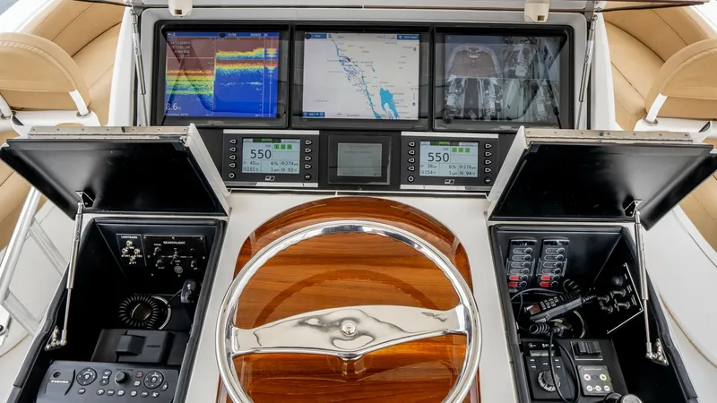Slide: The Image of Skybridge Helm Station The helm station of the Viking 92 Skybridge features state-of-the-art navigation and control systems. Three large multifunction displays offer comprehensive data, including navigation and engine performance. The polished wood and chrome steering wheel add - 6612575