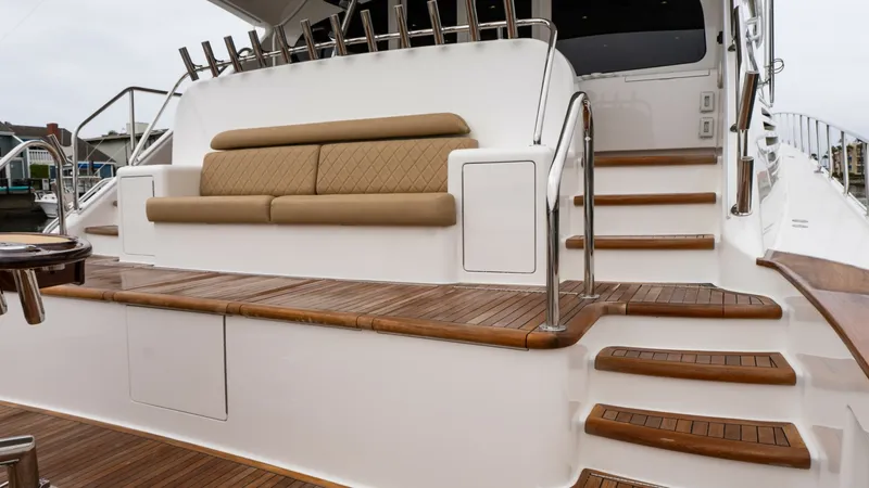 Slide: The Image of Aft Deck Seating Area The aft deck of the 2020 Viking 92 Skybridge features a luxurious seating area with plush cushions, perfect for relaxation and entertaining. The teak decking enhances the elegance and durability of the space, while the polished stainless steel railings ad - 6612563