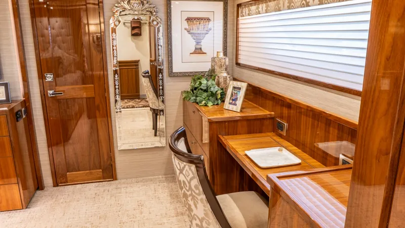 Slide: The Image of Elegant Vanity and Desk Area This inviting vanity and desk area aboard the Viking 92 Skybridge exudes warmth and sophistication. Rich wood finishes and elegant decor create a cozy yet luxurious atmosphere, perfect for relaxation or productivity. The space is complemented by ample nat - 6612543