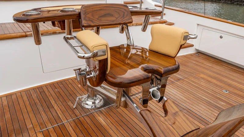 Slide: The Image of Teak Aft Deck with Fighting Chair The aft deck of the Viking 92 Skybridge 'AFTER MIDNIGHT' features a stunning teak finish and a premium fighting chair, ideal for sportfishing enthusiasts. The polished wood and chrome accents provide a luxurious touch, while the cushioned seating ensures - 6612567
