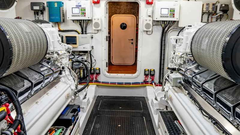 Slide: The Image of Engine Room with Dual Engines The engine room of the Viking 92 Skybridge showcases twin engines, highlighting the yacht's powerful performance capabilities. The space is meticulously organized, featuring advanced control panels and monitoring systems for optimal operation. The clean l - 6612561