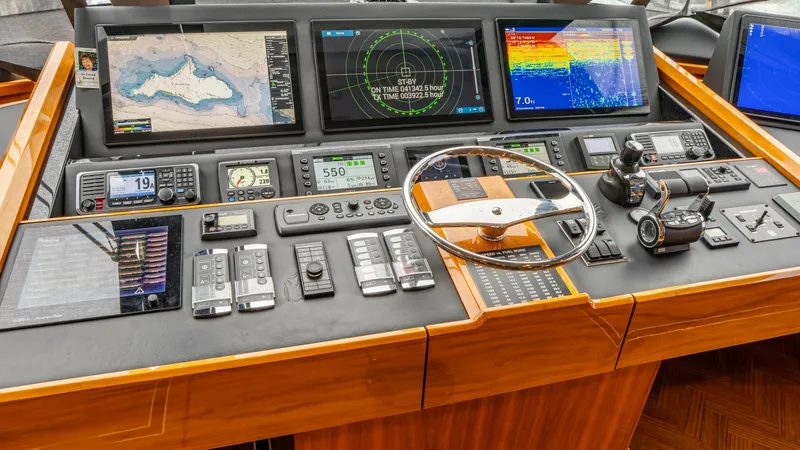 Slide: The Image of State-of-the-Art Helm Station This helm station on the 2020 Viking 92 Skybridge features cutting-edge navigation and control systems. The sleek console is equipped with multiple high-resolution displays for radar, GPS, and sonar, ensuring precise navigation. The polished wood finishes - 6612552