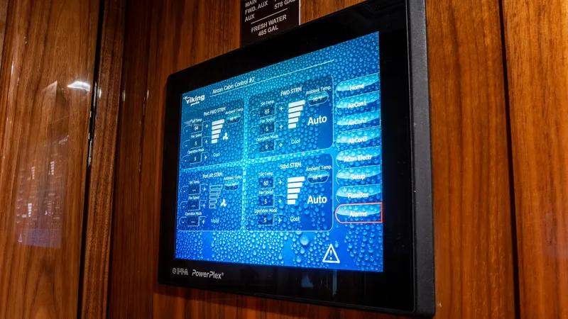 Slide: The Image of Digital Control Panel Interface This image showcases the advanced digital control panel on the Viking 92 Skybridge, providing intuitive access to the vessel's systems. The sleek interface is set against a rich wooden backdrop, enhancing the luxurious feel of the interior. This modern te - 6612549
