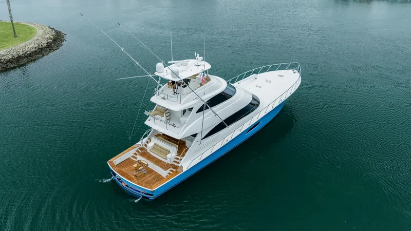 Slide: The Image of Aerial View of Aft Deck This aerial shot showcases the expansive aft deck of the 2020 Viking 92 Skybridge, 'AFTER MIDNIGHT'. The deck features elegant teak flooring and ample seating, perfect for entertaining or relaxing. The sleek lines and modern design of the vessel are accen - 6612579