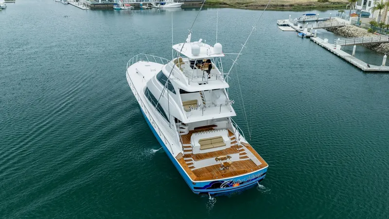 Slide: The Image of Aerial View of Aft Deck and Skybridge This striking aerial view showcases the expansive aft deck of the 2020 Viking 92 Skybridge. The deck features elegant teak flooring and ample seating, perfect for entertaining or relaxing. The skybridge offers exceptional visibility, providing a commandin - 6612580