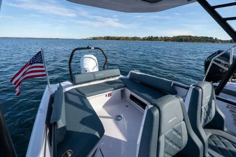 Slide: The Image of Axopar 22 T-Top Aft Seating and Outboard Engine Aft view of the Axopar 22 T-Top highlighting the U-shaped cockpit seating, transom layout, and outboard engine—blending comfort, utility, and sleek Nordic design. Captured by East Coast Yacht Sales in Casco Bay, Maine. - 7383412