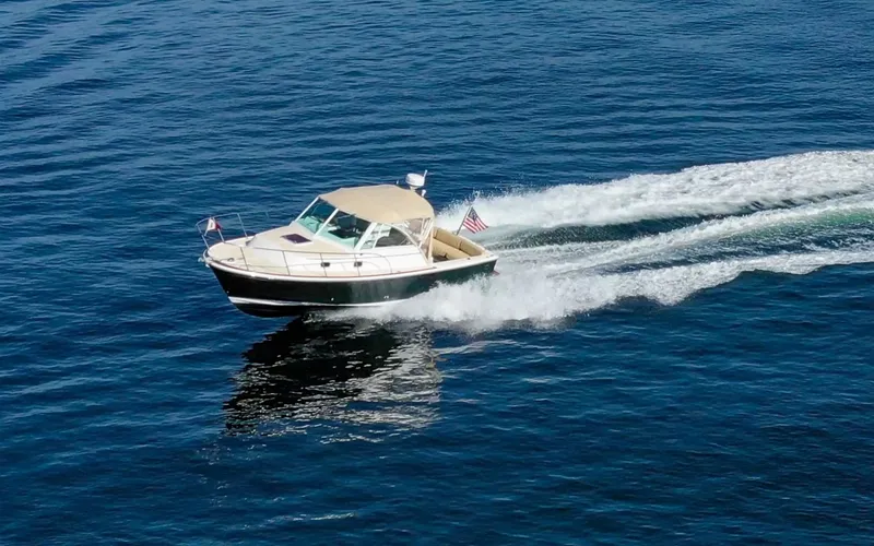 Slide: The Image of Hunt Surfhunter 29 - Judith Ann 2005 Hunt Yachts Surfhunter 29 cruising on open water, leaving a wake behind. - 6302488
