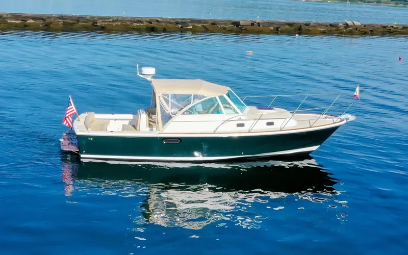 Slide: The Image of Hunt Surfhunter 29 - Judith Ann 2005 Hunt Yachts Surfhunter 29 boat on calm water with American flag. - 6302465