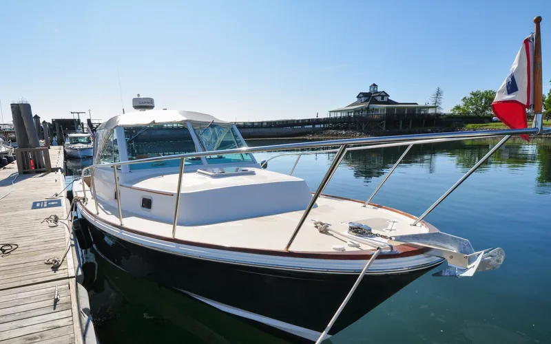 Slide: The Image of Hunt Surfhunter 29 - Judith Ann 2005 Hunt Yachts Surfhunter 29 docked, reflecting on calm water under clear blue sky. - 6302501