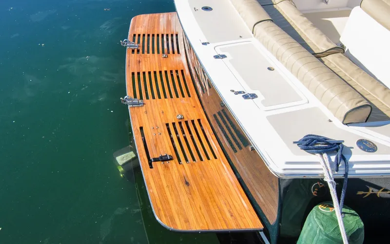 Slide: The Image of Hunt Surfhunter 29 - Judith Ann 2005 Hunt Yachts Surfhunter 29 swim platform with teak finish and cushioned seating. - 6302498